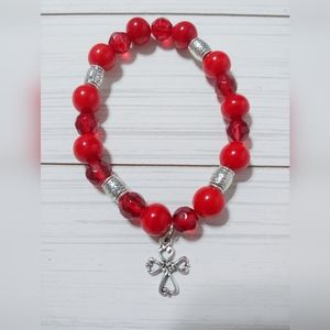 Red beaded stretch bracelet with cross charm
